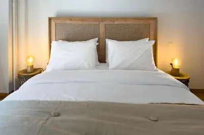 a large white bed with white pillows and two lamps at Phaedrus Living Kallithea Heights Residence in Athens