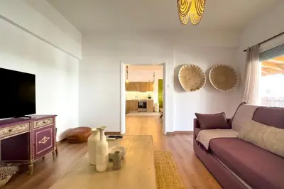 a living room with a couch and a tv at Phaedrus Living Kallithea Heights Residence in Athens
