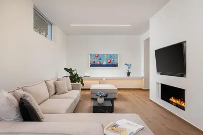 a living room with a couch and a fireplace at Athena's Lemon Grove Glyfada in Athens