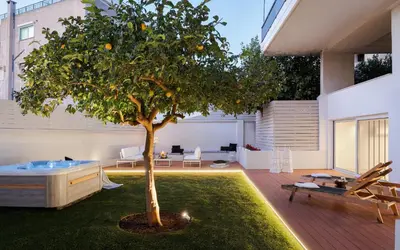 an orange tree in the middle of a living room at Athena's Lemon Grove Glyfada in Athens