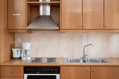 a kitchen with a sink and a stove at Spacious house with seaview in Porto Rafti