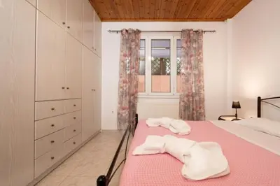 a bedroom with a bed with two towels on it at Spacious house with seaview in Porto Rafti