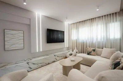 a living room with a couch and a tv at Acropolis Soul in Athens