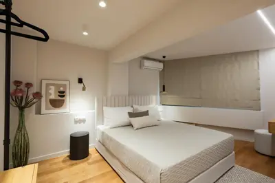 a bedroom with a white bed and a vase of flowers at Acropolis Soul in Athens