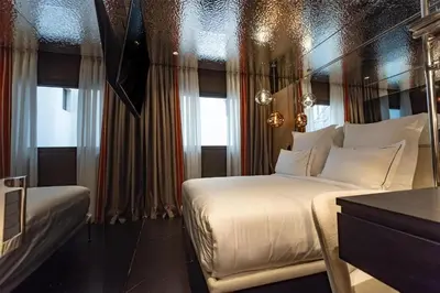 a hotel room with two beds and a window at Adia Aluma Athens, Curio Collection By Hilton in Athens