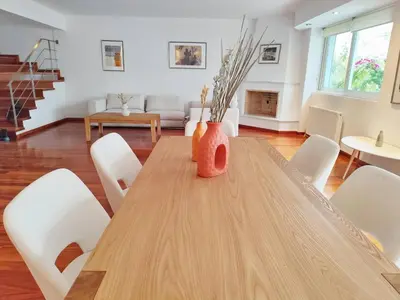 a dining room table with white chairs and a vase on it at Adelos II Glow Villa 5BR 360m -Elevator-Rooftop in Athens