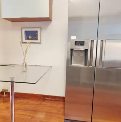 a kitchen with a glass table and a refrigerator at Adelos II Glow Villa 5BR 360m -Elevator-Rooftop in Athens