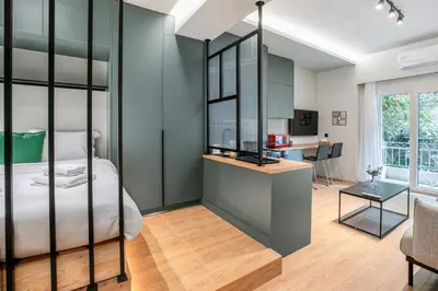 a bedroom with a bed and a desk in a room at Lyndon Deluxe Studio - Athens Modern Escape in Athens