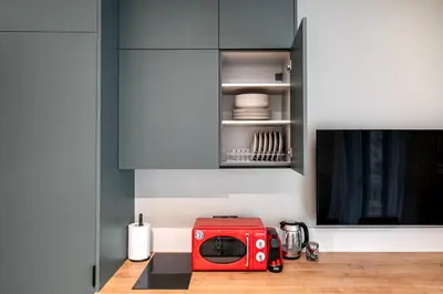 a red toaster sitting on a counter in a kitchen at Lyndon Deluxe Studio - Athens Modern Escape in Athens