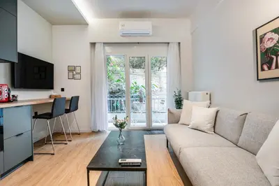 a living room with a couch and a table at Lyndon Deluxe Studio - Athens Modern Escape in Athens