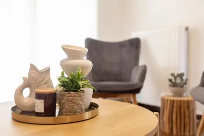 a table with vases and plants on top of it at Seaside Elegance Brand New 2BD Luxury Stay in Athens