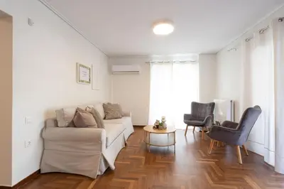 a living room with a couch and a table at Seaside Elegance Brand New 2BD Luxury Stay in Athens