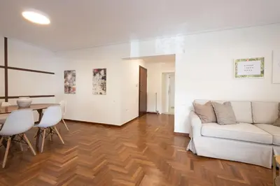 a living room with a couch and a table at Seaside Elegance Brand New 2BD Luxury Stay in Athens