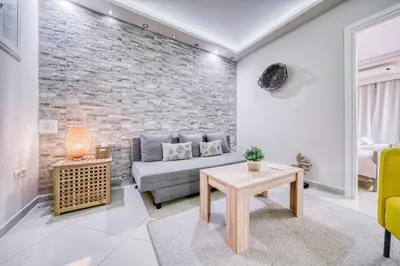 a living room with a couch and a table at So36 Filoxenia Place Like Home Kolonaki- next to metro and center in Athens