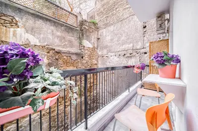 a balcony with flowers and plants on a wall at So36 Filoxenia Place Like Home Kolonaki- next to metro and center in Athens