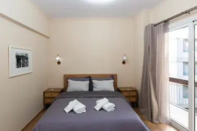 a bedroom with a bed with two towels on it at Central Athens Charm in Athens