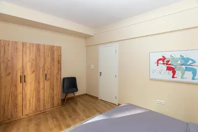 a bedroom with a bed and a painting on the wall at Central Athens Charm in Athens