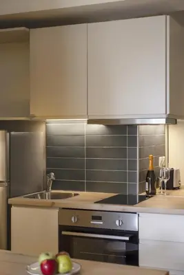 a kitchen with stainless steel appliances and a sink at Renovated Studio with Sea View in Palaio Faliro in Athens
