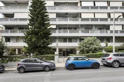 a group of cars parked in front of a building at Renovated Studio with Sea View in Palaio Faliro in Athens