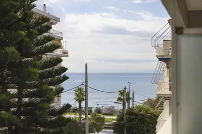 a view of the ocean from a building at Renovated Studio with Sea View in Palaio Faliro in Athens