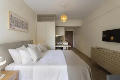 a bedroom with a large bed with white pillows at Renovated Studio with Sea View in Palaio Faliro in Athens