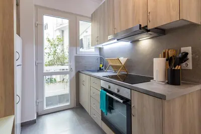 a kitchen with a stove top oven next to a window at Daedalus Minimal 1bedroom Bliss in Athens
