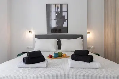 a bedroom with a bed with two towels on it at Daedalus Minimal 1bedroom Bliss in Athens