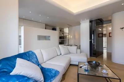 a living room with a white couch and a glass table at Culture and Luxury 2bed Flat with Acropolis Views in Athens