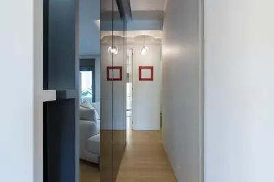 a room with a hallway with white walls and a mirror at Culture and Luxury 2bed Flat with Acropolis Views in Athens