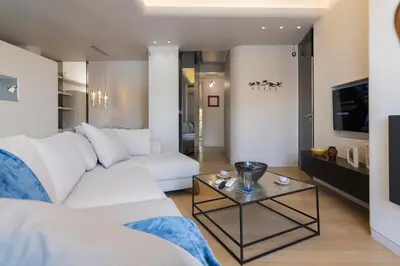 a living room with a white couch and a table at Culture and Luxury 2bed Flat with Acropolis Views in Athens