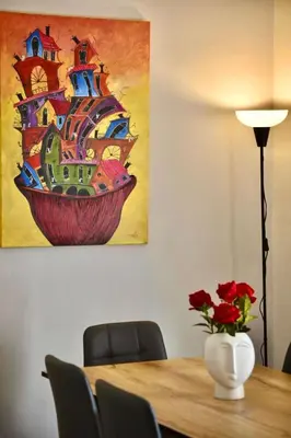 a painting of a ship in a vase on a table at Tete's Acropolis View Penthouse in Athens