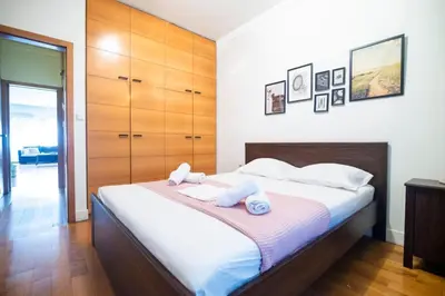 a bedroom with a bed with two towels on it at Kolonaki Haven - 2 BR, Kolonaki in Athens