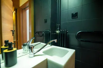 a bathroom with a sink and a mirror at Kolonaki Haven - 2 BR, Kolonaki in Athens