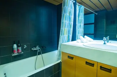 a bathroom with a tub and a sink and a bath tub at Kolonaki Haven - 2 BR, Kolonaki in Athens