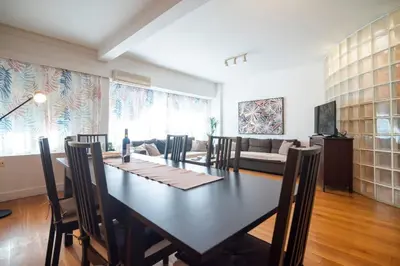 a dining room with a table and a couch at Kolonaki Haven - 2 BR, Kolonaki in Athens
