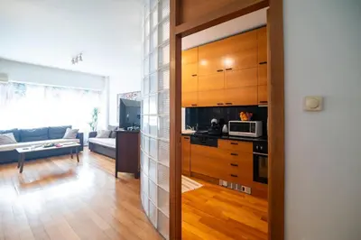 a kitchen and living room with a couch and a microwave at Kolonaki Haven - 2 BR, Kolonaki in Athens