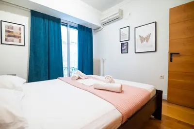 a bedroom with a bed with towels on it at Kolonaki Haven - 2 BR, Kolonaki in Athens