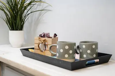 a tray with two coffee mugs and a box with a pencil at Cozy 1 BR Apt in Koukaki in Athens