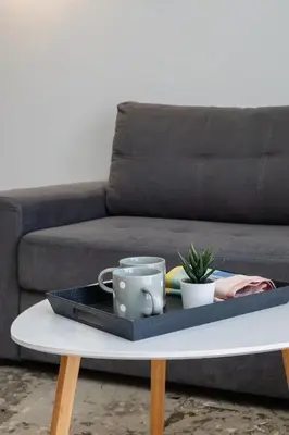 a tray on a coffee table with two cups on it at Cozy 1 BR Apt in Koukaki in Athens