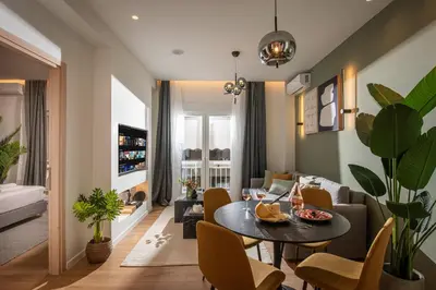 a living room with a table and a couch at Ant19- Stylish 1BR with Balcony in Central Athens in Athens