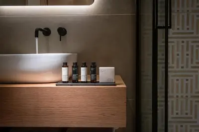 a bathroom with a sink and a counter with bottles ofodorizers at Ant19- Stylish 1BR with Balcony in Central Athens in Athens