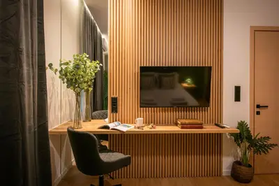 a room with a desk with a television and a chair at Ant19- Stylish 1BR with Balcony in Central Athens in Athens