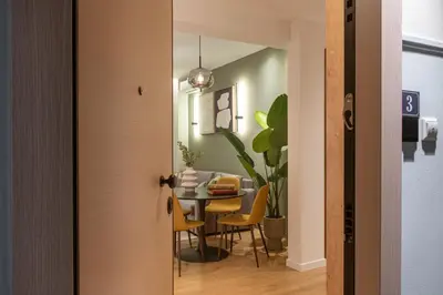 a dining room with a table and yellow chairs at Ant19- Stylish 1BR with Balcony in Central Athens in Athens