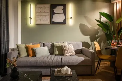 a living room with a gray couch with colorful pillows at Ant19- Stylish 1BR with Balcony in Central Athens in Athens