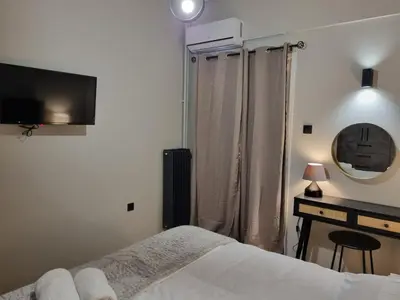 a bedroom with a bed and a television on the wall at Stylish Fully Renovated Apartment - Koukaki in Athens