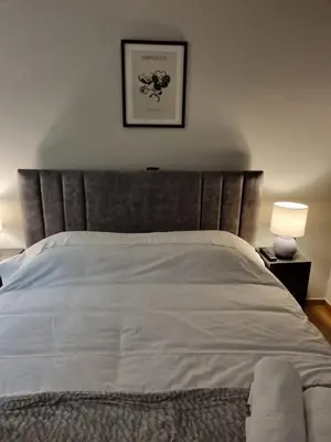 a bedroom with a large white bed and a lamp at Stylish Fully Renovated Apartment - Koukaki in Athens