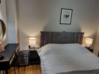 a bedroom with a bed with two lamps and a desk at Stylish Fully Renovated Apartment - Koukaki in Athens