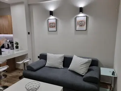 a living room with a couch and some pictures on the wall at Stylish Fully Renovated Apartment - Koukaki in Athens
