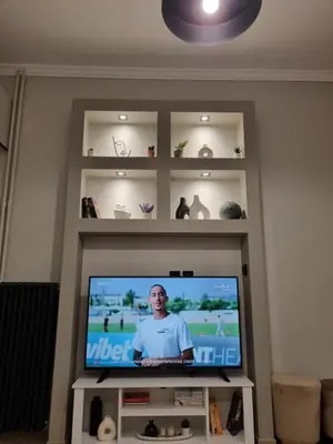 a flat screen tv in a living room at Stylish Fully Renovated Apartment - Koukaki in Athens
