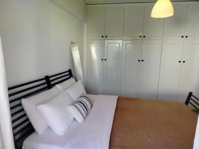 a bedroom with a white bed with white pillows at Emily's luxury apartment in Vari